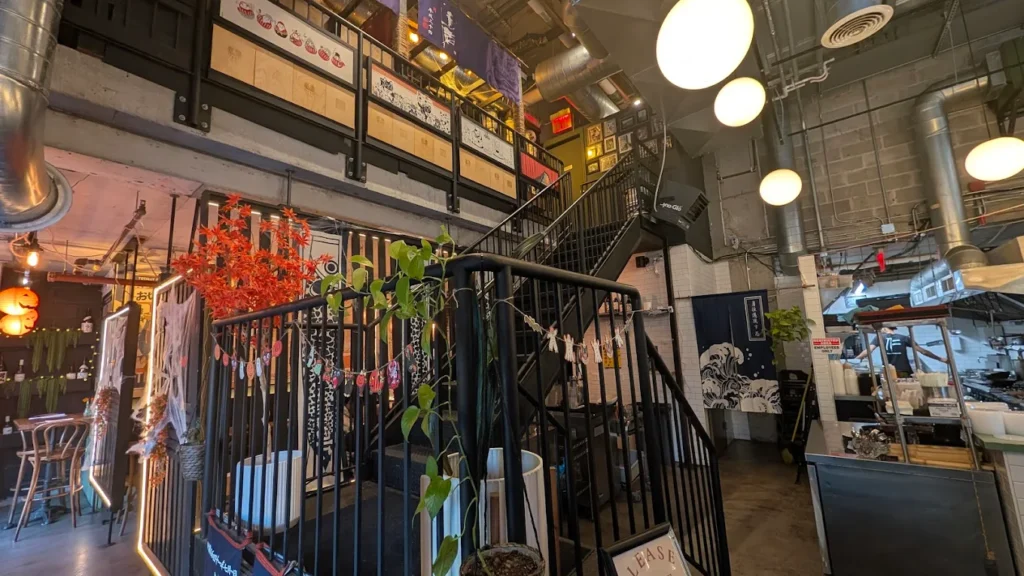 The black stairs inside Jin Ramen leading to the second floor, which is where the private dining area is located.