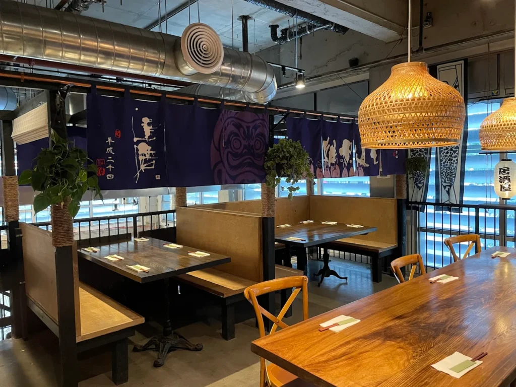 The private dining room of Jin Ramen, which includes two large booths and a long table. The seating could fit about 20 people.